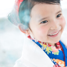 七五三記念に3歳の女の子が着物姿で笑顔を見せているスタジオルーチェイリュームでの撮影シーン。