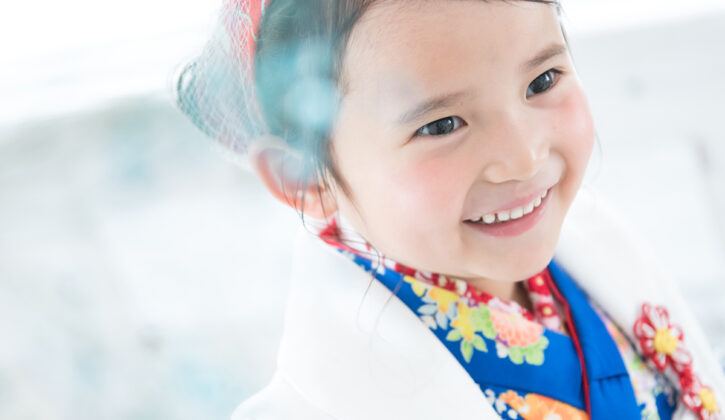 七五三記念に3歳の女の子が着物姿で笑顔を見せているスタジオルーチェイリュームでの撮影シーン。